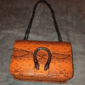 Orange snake skin handbag